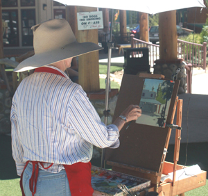 Elaine Matthews of Rancho Mirage paints in plein air at a previous AAI event. File photo