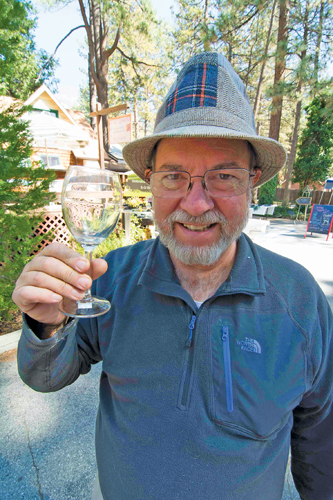Town Crier co-owner Jack Clark enjoys an afternoon celebrating the Art Alliance’s 16th-annual Art Walk and Wine Tasting on Saturday at the Oakwood Village courtyard adjacent to the Town Crier and Visitors Center office. More photos on page 14. Photo by John Pacheco