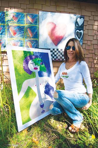 Artspresso Art Gallery owner Alexandria Taylor poses by one of the many works of art on display at the gallery Saturday afternoon. Artspresso was part of the Art Alliance of Idyllwild’s 16th-annual Art Walk and Wine Tasting.  Photo by John Pacheco