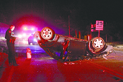 At right, according to California Highway Patrol Officer Mike Murawski, Jeanine Bernal, 32, of Idyllwild, was driving her 2000 blue Volkswagen Beetle northbound on Highway 243 near Jameson Drive Saturday night before midnight when she lost control, overturning the vehicle in the middle of the highway. An Idyllwild Fire Department ambulance transported Bernal to San Gorgonio Memorial Hospital with minor injuries to her face. According to witnesses, a male passenger fled the scene on foot up Jameson Drive from Highway 243 and was not located. Highway 243 was closed in both directions for more than an hour while the scene was cleared.Photo by Jenny Kirchner