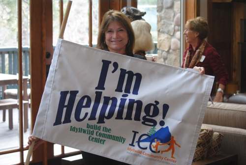 Diane Cardinalli displays the “I’m Helping Build the ICC” flag to local business people attending this week’s Idyllwild Community Center presentations.  Photo by J.P. Crumrine