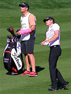 Brendan Steele and caddie Will Farish survey an approach shot during the second round of the Humana Challenge on the Nicklaus Private course in La Quinta. Farish took over for Steele’s regular caddie who experienced visa problems attempting to enter on a flight from New Zealand. Farish is an LAPD officer who was Steele’s teammate on the golf team at the University of California, Riverside. He is sporting a pink wrist cast obtained recently after laying down his motorcycle.Photo by Jack Clark