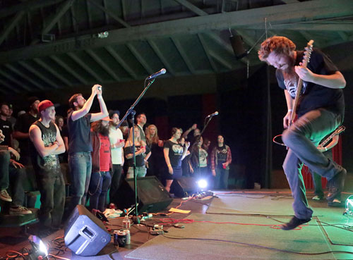 Michael Schnalzer, bass and lead vocals, evokes cheers and support from Saturday night’s crowd at the Rustic Theatre for a Throw the Goat performance.    Photo by Jenny Kirchner