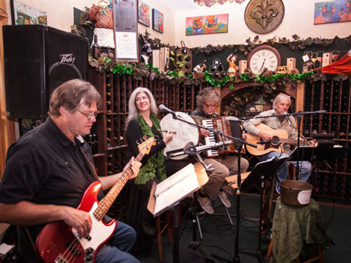 Monday night, St. Patrick’s Day, Two Micks and a Chick perform at Idyll Awhile Bistro & Wine Shoppe.  From left, Vince Day, Andrea Bond, Mick Lynch and John King. The group treated a standing-room-only crowd to Irish tunes. Photo by Peter Szabadi