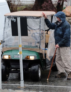 A little weather didn’t stop this resident in his golf cart Friday afternoon. Photo by  Jenny  Kirchner