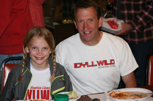 Cross-country runner Brooke Arnson (left) and father/coach Lee Arnson enjoy the spaghetti dinner the American Legion Post 800 hosted Saturday night to raise money for the cross-country team, the Mountain Lions. The teams are composed of children from fifth grade and up. Lee said the team needs money for jerseys and to fund bus travel to the meets in Temecula and Hemet. Grandma and Grandpa Neu organized the dinner and have been avid supporters. Photo by Jay Pentrack 