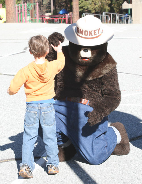 Smokey Bear and firefighters from the U.S. Forest Service spoke to preschool, kindergarten and first-grade students at Idyllwild Elementary School on fire safety Monday morning. Smokey gave out bear hugs and high-fives to the kids. Photo by  Jay Pentrack 