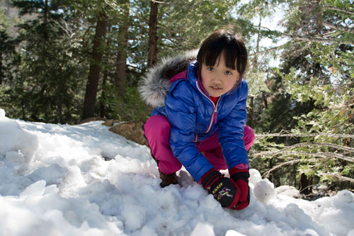 A dash of winter ... Chu Wong visited Idyllwild to play in the snow after the storms last week.  She and her family were surprised to find only small patches in Humber Park. Photo by John Pacheco