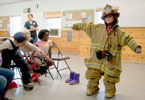 At Town Hall’s Spring Festival celebration, kids got to try on fire safety gear. The Idyllwild Fire Department discussed fire safety procedures on Tuesday, April 1. Photo by John Pacheco