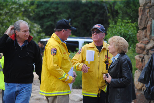 Riverside County 3rd District Supervisor Jeff Stone (left) visited the Incident Command Post at Idyllwild Pines Camp. Here he meets with Jay Orr, county executive officer, John Hawkins, county fire chief, and Edwina Scott, executive director of the Mountain Communities Fire Safe Council.  Photo by J.P. Crumrine.