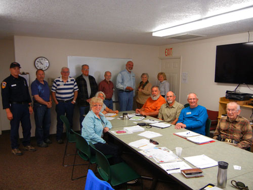 The Idyllwild Rotary Anns present an award to the Mountain Communities Fire Safe Council Woodies. Standing in the back (from left) are Mic Sebastian, Cal Fire; MCFSC directors Norm Walker and Ron Perry; volunteer Dan Dever; Project Manager Don Patterson; President Mike Esnard accepting the check from Rotary Ann Roberta Corbin; and Edwina Scott, MCFSC executive director. Seated in front (from left) are directors Lois Hensen, Doris Lombard, Jerry Holldber, Chris Kramer, Marvin Spreyn and Larry Kueneman. Photo by courtesy of Roberta Corbin 