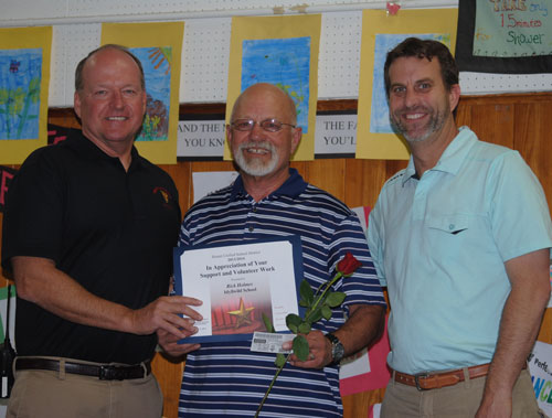 Rick Holmes (center) was recognized as Idyllwild School Volunteer of the Year at Friday’s Volunteer Reception. Idyllwild School Principal Matt Kraemer (left) and fourth-grade teacher Tom Dillon (right) honored Holmes’ contributions throughout the year. “He just shows up. He has one focus — helping kids. He’s equal with me,” Dillon said, describing Holmes efforts.  Photo by J.P. Crumrine