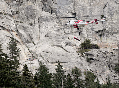 A female rock climber fell about 60 feet Sunday morning while climbing near Lunch Rock on Lily Rock, injuring her right ankle, leg and hip. Fire personnel from Riverside County Fire and Idyllwild Fire responded to Humber Park, sending crews on foot to meet with the patient. Cal Fire Helicopter 301 hoists the patient while other climbers (left) watch on. She was transported to Riverside Regional Medical Center to be treated for her injuries.  Photo by Jenny Kirchner