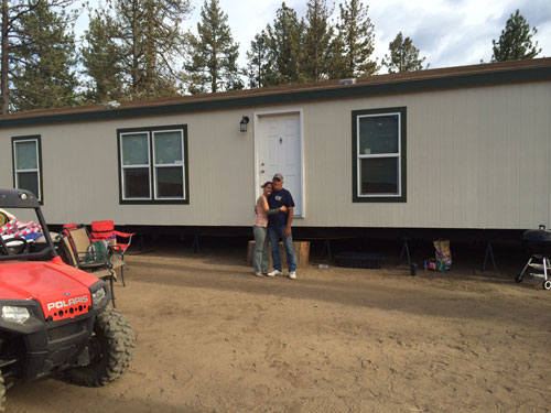 Sasha Fisher and Marty Prevosto stand in front of their new home in Bonita Vista.   Photo by Marshall Smith