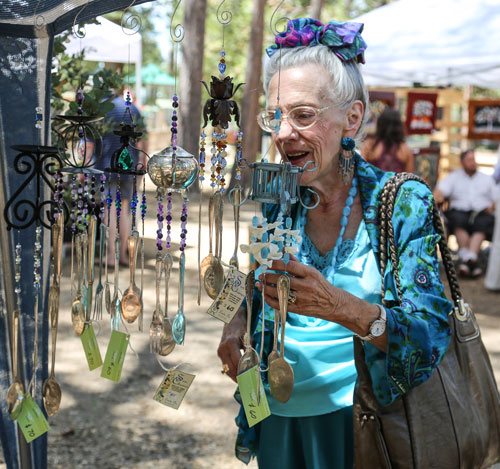 Alice Lindsey eyes the utensil chimes at the 2nd Saturday Art Fair held at the Idyllwild Community Center and sponsored by the Art Alliance of Idyllwild. Photo by Cheryl Basye  