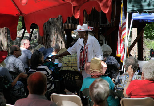 From the pews, one of the attendees at Idyllwild Community Church joins in a gospel song with “Ms. Lillie” Knauls, who returned to sing again at Sunday service July 6.  Photo by John Drake