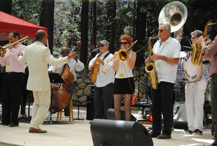 The Euphoria Brass Band surprised Evan Christopher (second from left) when they paraded down the Holmes Amphitheatre as Christopher and other Idyllwild Arts alumni finished their performance Saturday afternoon. Jason Jackson (left) is on trombone, Henry Franklin on bass, and Bob Boss is on guitar and The Euphoria Brass Band members are on the right.           Photo by J.P. Crumrine
