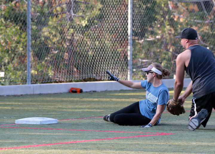 Emily White, playing for Creekstone Inn, slides safely into third base Wednesday while playing adult coed softball against Forest Lumber.        Photo by Jenny Kirchner 