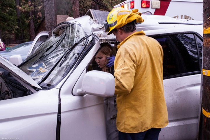 At about 3:40 p.m. Saturday during a rainstorm, Madison Clowdus, 18, of Temecula, lost control of her vehicle and struck a tree and utility pole on Highway 243 just south of Riverside County Playground Road. She had to be cut from her vehicle and was transported to Riverside County Regional Medical Center with non-life-threatening injuries. Photo by Peter Szabadi