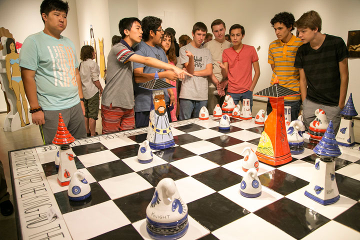 ART OF THE GAME: A large hand-made chessboard was set up in the middle of the room. Students compete with each other at some games of chess Friday night during the visual art show opening at Parks Exhibition Center on the Idyllwild Arts campus. Photo by Jenny Kirchner 