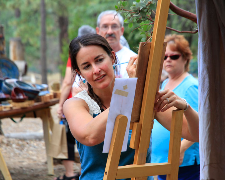 iverside Mountain Rescue Unit member and Town Crier columnist Helene Lohr creating art in front of her booth “Windwoodstone.”  Photo by John Drake