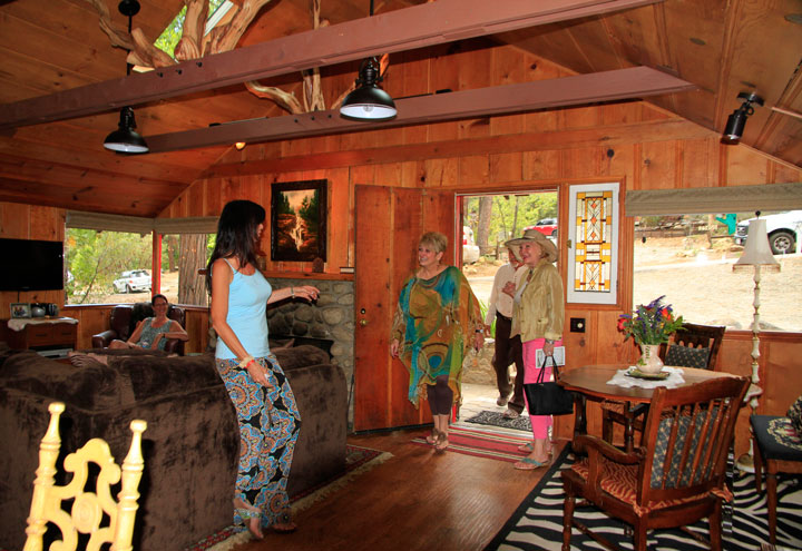 Homeowner Valerie McClure (left) greets locals Barbara Rayliss and Margaret McTague visiting her home as part of the Idyllwild Home Tour. The annual event attracts hundreds of visitors to five unique homes in the Idyllwild area and provides funds for the work of the Idyllwild Area Historical Society.Photo by John Drake 