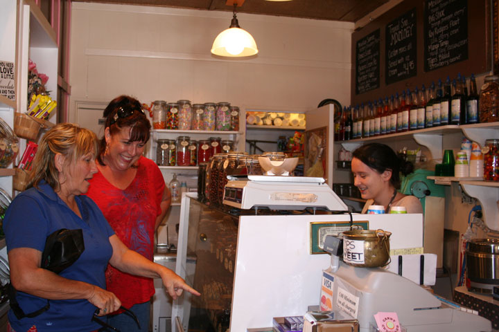 Christine Keller (at back) of Moreno Valley and her aunt, Marilyn Laughlin (left) of Orlando, Florida, take advantage of the discount at The Candy Cupboard last Wednesday in honor of its founder, Patty McKee, who passed away a year ago. Employee Kathleen Whitman assists the Idyllwild visitors. Photo by Becky Clark 
