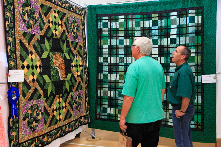 Scott Fisher (left) and Eliott Taylor take in one of the many grand quilts during the weekend Quilt Show at Buckhorn Camp. Photo by John Drake 