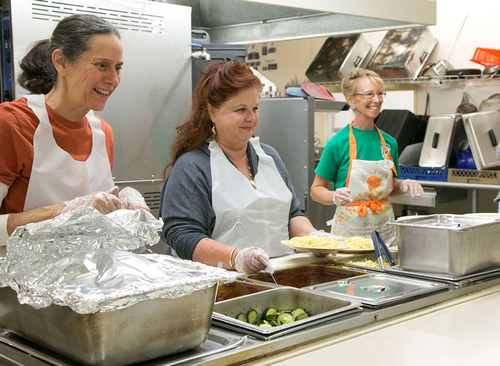 From left, Patty Carratello, Phyllis Brown and Debi Norton serve spaghetti, salad and garlic bread to hungry customers during the annual Soroptimist International of Idyllwild Basket Festival and Spaghetti Dinner. Photo by Jenny Kirchner