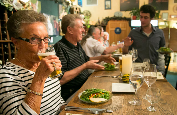 BEER TASTING: At left, part-time Idyllwild residents Gladys and Tom Flanagan enjoy the Octoberfest beer and food pairing Tuesday, Oct. 7, at Idyll Awhile. Pourer and beer expert Jared Dillon is standing.        Photo by Jenny Kirchner