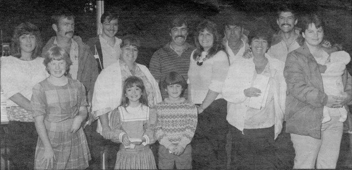 Family members at a dedication of a new, 25-foot flagpole at Town Hall in memory of Eleanor and Jerry Johnson, who donated the land for the Town Hall building. The family members in October 1985 were, from left,  back row, Paulette Johnson, Jerry Johnson, Willy Anderson, Jo Ann Anderson, Tommy Adamson, Jenny Adamson, Tom Adamson, Carol Ann Adamson, Rick Adamson and Kim Adamson with son, Chad. From row, Allison Johnson, Meghan Adamson and Kori Johnson. The names of contributors who raised $650 for the pole were buried in a canister under the flagpole.               File photo