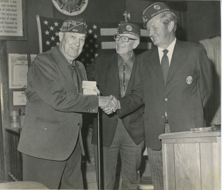 Dwight Metcalfe (left) receives a life membership card to American Legion Post 800 in November 1974. John Reed (right) made the presentation with George Fates. File Photo