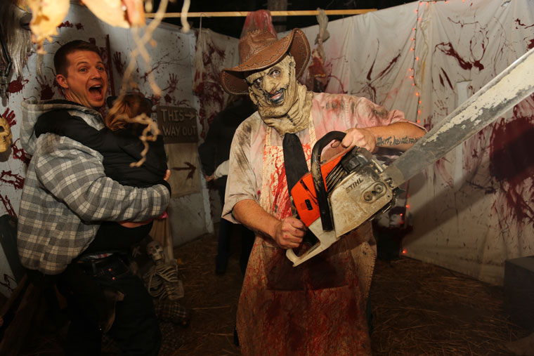 Jared Wilkinson is frightened by the chainsaw ghoul.