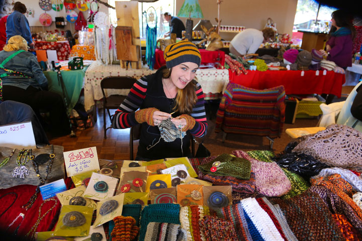 CRAFT FAIRE: Jen Wilcoxson knits while displaying her work during Saturday’s Garner Valley Craft Faire at the Common building. Photo by Cheryl Basye 