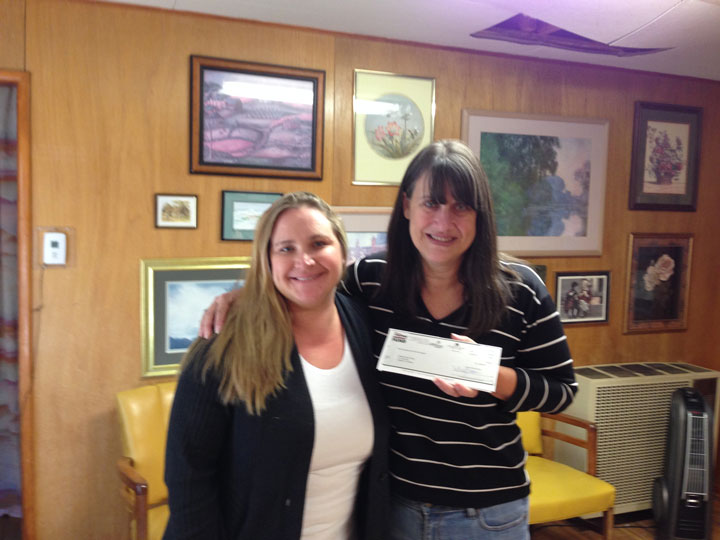 The Idyllwild HELP Center received a $5,000 medical grant to assist those in need that will start Dec. 2. From left is the center’s Client Services Administrator Colleen Meyer and Disney Cast member Julia Ledesma, who delivered the check. The grant falls under the Disney voluntEARS program, where a Disney cast member volunteers and nominates a non-profit to receive a grant. Photo by Karen Patterson 