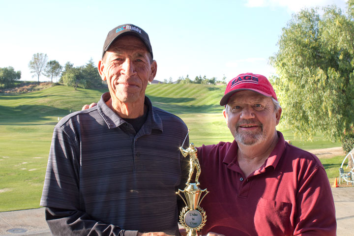 Palms to Pines Handicap Chair Jim Crandall (right) presents the 2014 Robert Stearns Memorial Club Champion trophy to John Brower, who won the championship last month. Brower will go on to represent the club in the Southern California Golf Association Tournament of Club Champions in December.  Photo by Gary Brown