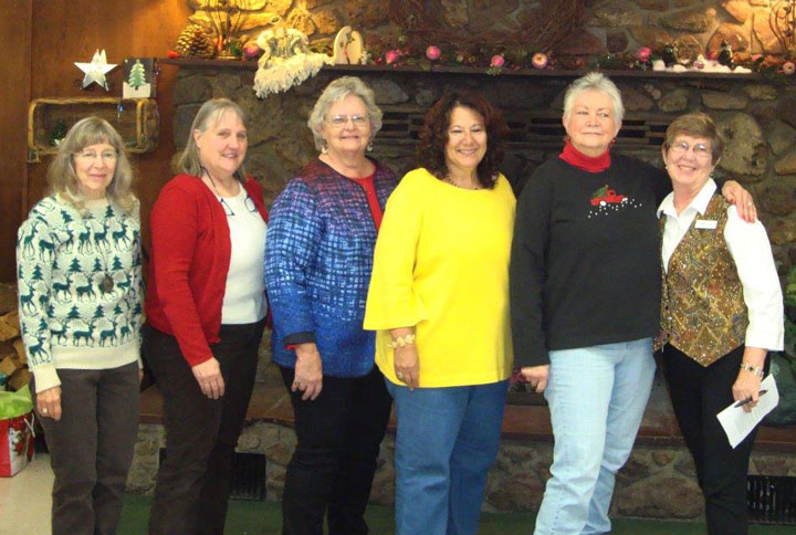 Mountain Quilters of Idyllwild announced new officers at their annual holiday party Tuesday, Dec. 9, at Buckhorn Camp. From left, Barbara Pelham, vice president/membership; Chris Finney, first vice president/programs; Karen Doshier, treasurer; Carmen Curiel-Terrazas, president-elect; Judy Lawler, secretary; and Diana Kurr, president. The 2015 Opportunity Quilt, “Where the Deer Play,” was displayed, and the tree was surrounded with many gifts the guild members collected for the families registered with the Idyllwild HELP Center. Photo courtesy pat hughes 