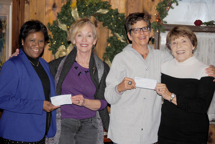 The Associates of Idyllwild Arts Foundation presented two checks to the school Friday, Dec. 12. Pamela Jordan (far left), president of the Idyllwild Arts Foundation, accepts a check from Anne Erikson, Associates president. Karen Metz, (far right) chair of the Associates’ Endowment Committee, accepts the second check from Pam Goldwasser, co-chair of the 2014 Jazz in the Pines Festival. Photo by J.P. Crumrine 