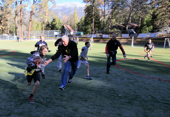 During the annual Holiday Bowl between students and teachers at Idyllwild School, one of the students narrowly escapes teacher George Companiott. Photo by John Drake