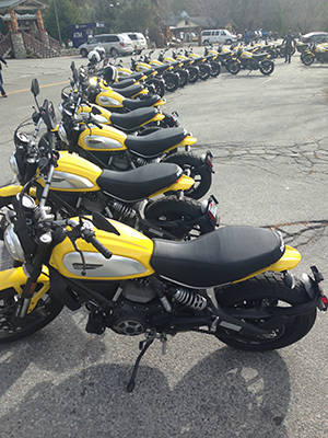 Ducati Motor Holding S.p.A. of Bologna, Italy, chose the Palms to Pines Highway between Palm Springs and Idyllwild for its current promotion of its new 2015 Ducati Scrambler. Monday some 35 bright-yellow Scramblers, ridden by journalists from various countries, parked along Village Center Drive to enjoy breakfast and coffee before heading out to Camp Ronald McDonald for a luncheon and their return to Palm Springs. According to Mario Alvisi, the Ducati Scrambler brand director who was leading the group, this is the second of three Palms to Pines promotional trips planned for December, each with journalists from different countries world wide. He stated the Palm Springs - Idyllwild connection was selected because of its gorgeous scenery and interesting roadways for motorcycle travel. They will be shooting photos and videos during each of these trips. Photo by Jack Clark