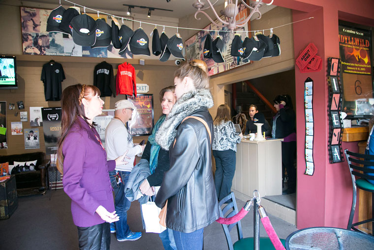 Volunteers and IIFC patrons chat in the lobby of the rustic theater Thursday afternoon. Photo by Jenny Kirchner