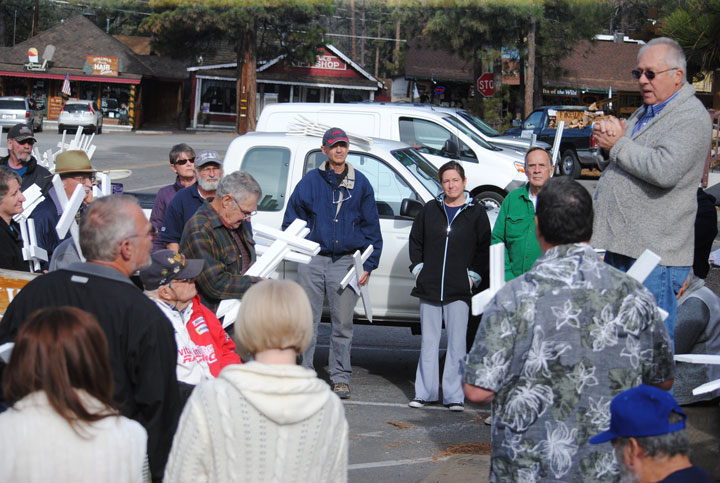 John Cook, speaks to the group in front of the town monument Wednesday, Jan. 21, before they begin their journey of planting crosses at four local churches. Photo by JP Crumrine