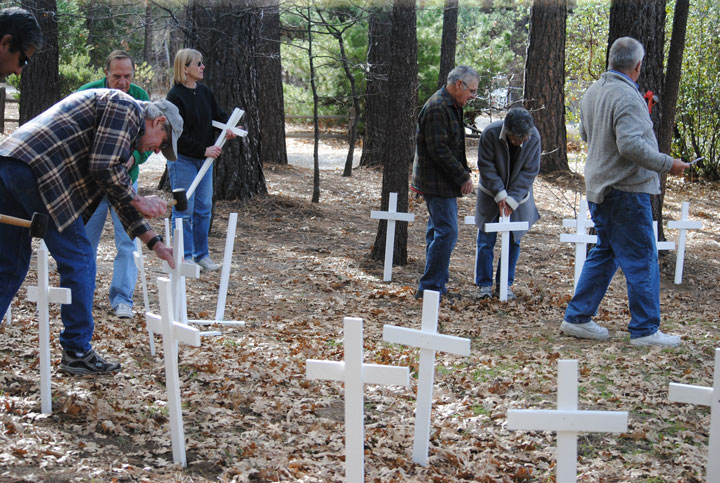 At Queen of Angels, the first of four Hill churches, 57 crosses were placed. Photo by JP Crumrine