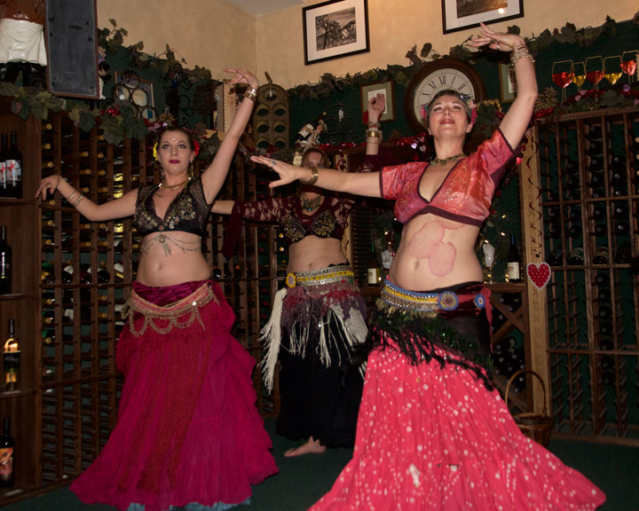 ECLECTIC ENTERTAINMENT: Jessie Estrada (left), Christina Nordella (back), and Rachel Welch (right) entertain patrons at Idyll Awhile Wine Shoppe Bistro with a night of belly dancing last Thursday. Photo by John Drake 