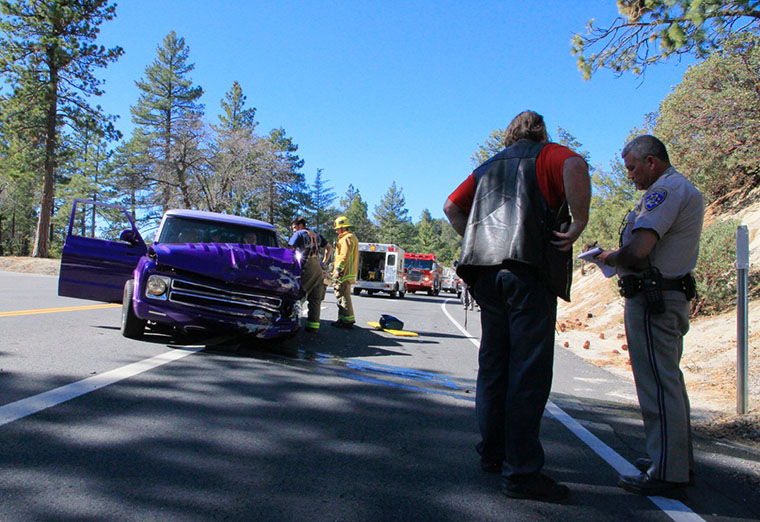 Idyllwild resident Robert Dunn looks over his Suburban after a collision with a Toyota 4Runner about 11:45 a.m. Sunday in front of the Nature Center on Hwy. 243. Dunn's classic car sustained major damage to the front end. Photo by John Drake