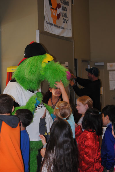 Thunder — tall, green and goofy mascot of the Lake Elsinore Storm minor league baseball team — high-five’s Idyllwild School students after a presentation encouraging students to read and be healthy. Photo by Marshall Smith