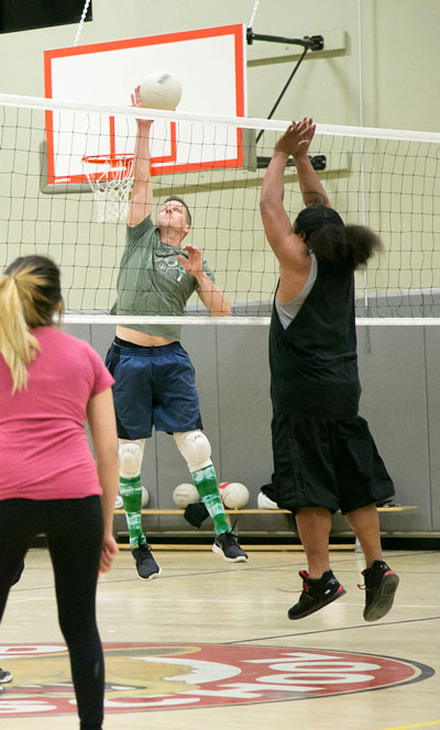 Josh White playing for Idyllwild Inn spikes the ball against the Native Islanders during Tuesday night’s Town Hall Adult Volleyball game at Idyllwild School. 