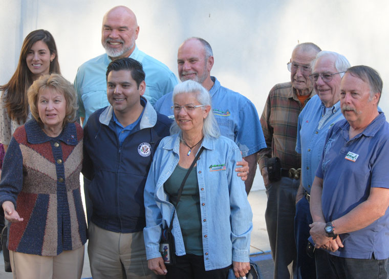 Following his tour of the Mountain Fire burned area, Congressman Dr. Raul Ruiz (front, second from left) met with the Mountain Communities Fire Safe Council. Afterward all stood for a photo. (Front, from left) Edwina Scott, MCFSC executive director, Ruiz and Doris Lombard, director. (Second row, from left) Jamie Patton, Ruiz’s district director, Mike Esnard, director, Chris Kramer, MCFSC president, Larry Kueneman, second vice president, Ron Perry, director, and Norm Walker, first vice president. Photo by J.P. Crumrine