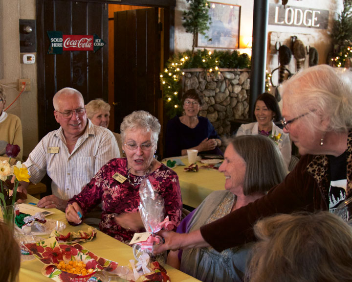 Docent and volunteer for the Idyllwild Area Historical Society, Sharla Carpenter, receives one of the door prizes from President Marlene Pierce at the annual volunteer luncheon on Wednesday, April 15.Photo by John Drake 