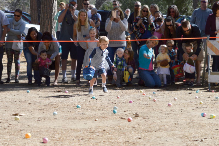 Luke Olivier, 3, darts out to get a head start on Saturday’s Community Easter Egg Hunt at the Idyllwild Community Park. Photo by Gallagher Goodland